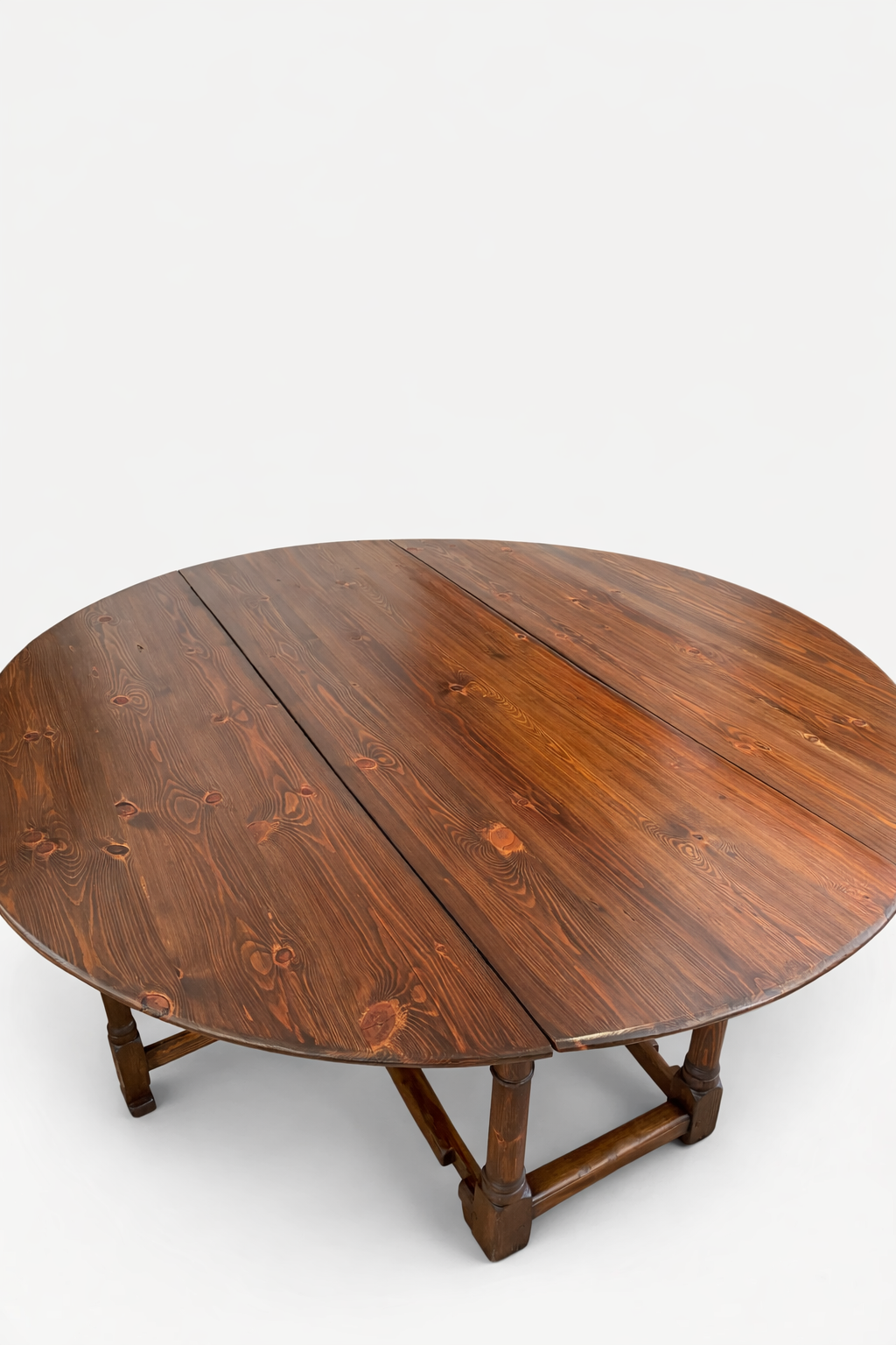 Refinished round wooden dining table in The Woodpecker Tampa’s furniture portfolio
